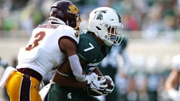 EAST LANSING, MI - SEPTEMBER 29: Cody White #7 of the Michigan State Spartans battles for yards while being tackled by Sean Bunting #3 of the Central Michigan Chippewas aftar a first half catch at Spartan Stadium on September 29, 2018 in East Lansing, Michigan. (Photo by Gregory Shamus/Getty Images)