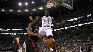 Mar 23, 2016; Boston, MA, USA; Boston Celtics forward Amir Johnson (90) reacts after dunking the ball in front of Toronto Raptors center Bismack Biyombo (8) during the second half at TD Garden. Mandatory Credit: Bob DeChiara-USA TODAY Sports