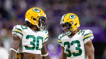 Dec 23, 2019; Minneapolis, Minnesota, USA; Green Bay Packers running back Jamaal Williams (30) and running back Aaron Jones (33) warm up before a game against the Minnesota Vikings at U.S. Bank Stadium. Mandatory Credit: Brad Rempel-USA TODAY Sports