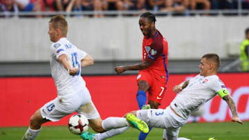 TRNAVA, SLOVAKIA - SEPTEMBER 04: Raheem Sterling of England shoots past Martin Skrtel and Tomas Hubocan of Slovakia during the 2018 FIFA World Cup Group F qualifying match between Slovakia and England at City Arena on September 4, 2016 in Trnava, Slovakia. (Photo by Michael Regan - The FA/The FA via Getty Images)