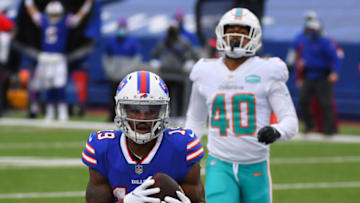Jan 3, 2021; Orchard Park, New York, USA; Buffalo Bills wide receiver Isaiah McKenzie (19) catches a pass for a touchdown as Miami Dolphins defensive back Nik Needham (40) looks on during the second quarter at Bills Stadium. Mandatory Credit: Rich Barnes-USA TODAY Sports