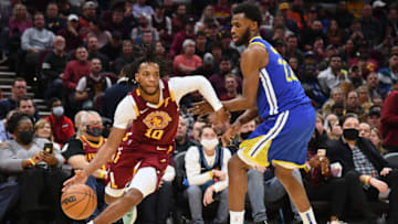 CLEVELAND, OHIO - NOVEMBER 18: Darius Garland #10 of the Cleveland Cavaliers drives to the basket around Andrew Wiggins #22 of the Golden State Warriors during the second half at Rocket Mortgage Fieldhouse on November 18, 2021 in Cleveland, Ohio. The Warriors defeated the Cavaliers 104-89. NOTE TO USER: User expressly acknowledges and agrees that, by downloading and/or using this photograph, user is consenting to the terms and conditions of the Getty Images License Agreement. (Photo by Jason Miller/Getty Images)