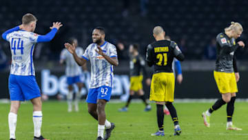 Borussia Dortmund players looked dejected after the game as Hertha player celebrate. (Photo by Boris Streubel/Getty Images)