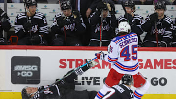 Apr 5, 2022; Newark, New Jersey, USA; New York Rangers defenseman Braden Schneider (45) hits New Jersey Devils center Jesper Boqvist (70) during the first period at Prudential Center. Mandatory Credit: Ed Mulholland-USA TODAY Sports