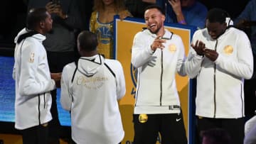 OAKLAND, CA - OCTOBER 16: Kevin Durant #35 and Stephen Curry #30 of the Golden State Warriors laugh during the 2017-2018 Championship ring ceremony prior to their game against the Oklahoma City Thunder at ORACLE Arena on October 16, 2018 in Oakland, California. NOTE TO USER: User expressly acknowledges and agrees that, by downloading and or using this photograph, User is consenting to the terms and conditions of the Getty Images License Agreement. (Photo by Robert Reiners/Getty Images)