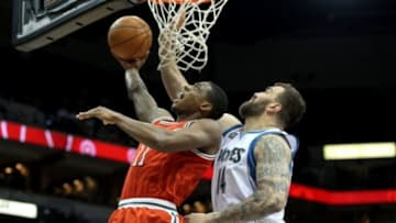 Mar 11, 2014; Minneapolis, MN, USA; Milwaukee Bucks guard Brandon Knight (11) shoots over Minnesota Timberwolves center Nikola Pekovic (14) during the first quarter at Target Center. Mandatory Credit: Brace Hemmelgarn-USA TODAY Sports