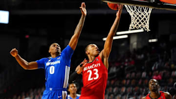 Cincinnati Bearcats guard Mika Adams-Woods scores against the Memphis Tigers. The Enquirer.