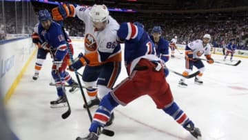 Oct 14, 2014; New York, NY, USA; New York Islanders left wing Nikolai Kulemin (86) battles for the puck with New York Rangers defenseman Marc Staal (18) during the third period at Madison Square Garden. The Islanders won 6-3. Mandatory Credit: Brad Penner-USA TODAY Sports
