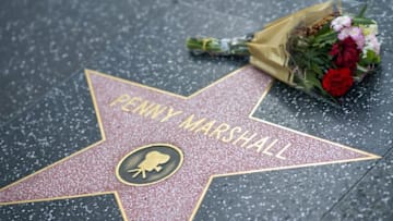 Fans leave tributes on Penny Marshall's star on the Hollywood Walk of Fame shortly after the news that the actress died aged 75 was made public, in Hollywood, California, on December 18, 2018. - Penny Marshall, the star of ABC's "Laverne and Shirley" who became one of the most successful female directors in history at the helm of "Big," "A League of Their Own" and a string of other hit movies, has died. She was 75. The filmmaker died peacefully in her Hollywood Hills on Monday, December 17, 2018 due to complications from diabetes, her publicist told AFP. (Photo by VALERIE MACON / AFP) (Photo credit should read VALERIE MACON/AFP/Getty Images)