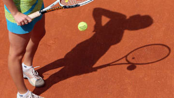 The shadow of Ukrainian player Kateryna Bondarenko is seen as she concentrates before serving to Swiss player Patty Schnyder during their French Tennis Open second round match at Roland Garros, 31 May 2007 in Paris. Schnyder won 6-3, 6-2. AFP PHOTO / THOMAS COEX (Photo credit should read THOMAS COEX/AFP via Getty Images)