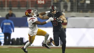 Dec 5, 2015; Santa Clara, CA, USA; Stanford Cardinal running back Christian McCaffrey (5) stiff arms Southern California Trojans cornerback Iman Marshall (8) on a kickoff return during the first quarter in the Pac-12 Conference football championship game at Levi