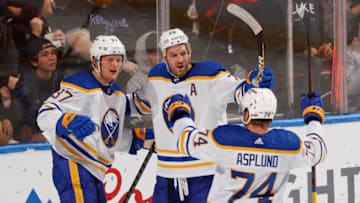 SUNRISE, FL - DECEMBER 2: Casey Mittelstadt #37 of the Buffalo Sabres celebrates his goal with Rasmus Asplund #74 and Zemgus Girgensons #28 during second-period action against the Florida Panthers at the FLA Live Arena on December 2, 2021 in Sunrise, Florida. (Photo by Joel Auerbach/Getty Images)