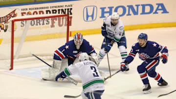 Amerks goalie Ukko-Pekka Luukkonen keeps his eye on the puck while teammate Ryan Scarfo deflects the puck that Utica’s Jack Rathbone was trying to control. Waiting to assist Rathbone was Sven Baertschi. The Rochester Americans hosted the Utica Comets at the War Memorial at Blue Cross Arena in Rochester on March 3, 2021. Because of COVID-19 they are currently not allowing fans to watch the game in person. The games can be heard on ESPN Rochester radio station or AHLTV.Covid Play In Front Of Amerks Net