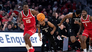 Houston Cougars forward Jarace Walker grabs a loose ball against Cincinnati Bearcats at Fifth Third Arena. The Enquirer.