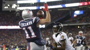 Jan 10, 2015; Foxborough, MA, USA; New England Patriots wide receiver Julian Edelman (11) attempts to catch the ball in front of Baltimore Ravens cornerback Lardarius Webb (21) during the second quarter in the 2014 AFC Divisional playoff football game at Gillette Stadium. Mandatory Credit: David Butler II-USA TODAY Sports