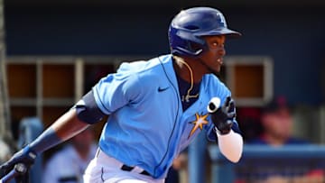 PORT CHARLOTTE, FLORIDA - FEBRUARY 24: Vidal Brujan #22 of the Tampa Bay Rays hits the ball during the sixth inning of a baseball game against the Boston Red Sox at Charlotte Sports Park on February 24, 2020 in Port Charlotte, Florida. (Photo by Julio Aguilar/Getty Images)