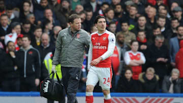 LONDON, ENGLAND - FEBRUARY 04: Injured Arsenal defender Hector Bellerin is led from the pitch by physio Colin Lewin during the Premier League match between Chelsea and Arsenal at Stamford Bridge on February 4, 2017 in London, England. (Photo by Stuart MacFarlane/Arsenal FC via Getty Images)