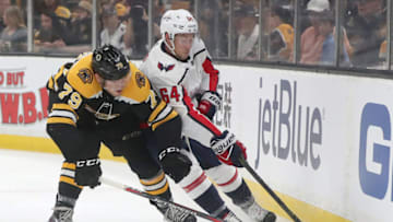 BOSTON - SEPTEMBER 16: Boston Bruins' Jeremy Lauzon battles with Washington Capitals Brian Pinho for control of the puck during the first period. The Boston Bruins host the Washington Capitals in a preseason NHL hockey game at TD Garden in Boston on Sep. 16, 2018. (Photo by Matthew J. Lee/The Boston Globe via Getty Images)