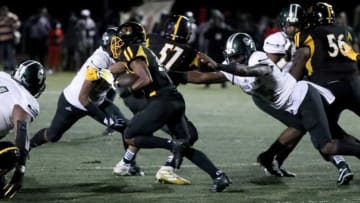 Cass Tech's Jalen Thompson dives at Detroit King's Tim Ruffin during the PSL Division 1-2 final Friday, Oct. 15, 2021.Preps 1 2