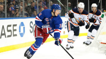 Oct 12, 2019; New York, NY, USA; New York Rangers right wing Kaapo Kakko (24) skates with the puck in front of Edmonton Oilers defenseman Joel Persson (36) during the second period against the Edmonton Oilers at Madison Square Garden. Mandatory Credit: Vincent Carchietta-USA TODAY Sports