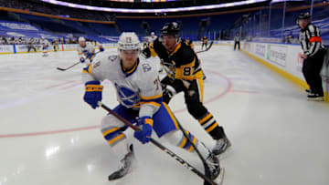 Mar 11, 2021; Buffalo, New York, USA; Buffalo Sabres defenseman Jacob Bryson (78) clears the puck along the boards as Pittsburgh Penguins center Sidney Crosby (87) defends during the third period at KeyBank Center. Mandatory Credit: Timothy T. Ludwig-USA TODAY Sports