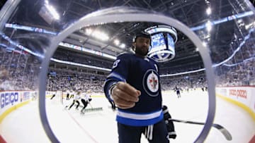 WINNIPEG, MB - MAY 12: Dustin Byfuglien #33 of the Winnipeg Jets picks up debris off the ice during a third period stoppage in play against the Vegas Golden Knights in Game One of the Western Conference Final during the 2018 NHL Stanley Cup Playoffs at the Bell MTS Place on May 12, 2018 in Winnipeg, Manitoba, Canada. (Photo by Darcy Finley/NHLI via Getty Images)