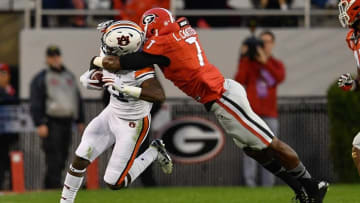 Nov 12, 2016; Athens, GA, USA; Auburn Tigers wide receiver Eli Stove (12) is tackled by Georgia Bulldogs linebacker Lorenzo Carter (7) during the second half at Sanford Stadium. Georgia defeated Auburn 13-7. Mandatory Credit: Dale Zanine-USA TODAY Sports