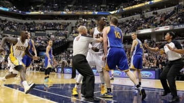 Feb 26 2013; Indianapolis, IN, USA; Officials try to separate a fight between Indiana Pacers center Roy Hibbert (55) and Golden State Warriors center David Lee (10) at Bankers Life Fieldhouse. Mandatory Credit: Brian Spurlock-USA TODAY Sports
