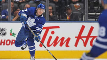 Travis Dermott #23 of the Toronto Maple Leafs fires a stretch pass to teammate Andreas Johnsson #18 against the Boston Bruins during an NHL game at Scotiabank Arena. (Photo by Claus Andersen/Getty Images)