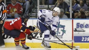 Sep 26, 2013; Estero, FL, USA; Tampa Bay Lightning left wing Jonathan Drouin (27) skates with the puck as Florida Panthers defenseman Erik Gudbranson (44) defends during the second period at Germain Arena. Mandatory Credit: Kim Klement-USA TODAY Sports
