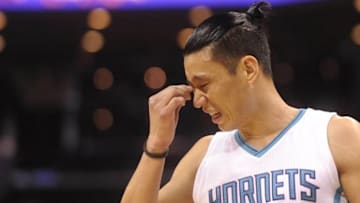 Apr 29, 2016; Charlotte, NC, USA; Charlotte Hornets guard Jeremy Lin (7) reacts after a hard hit during the first half in game six of the first round of the NBA Playoffs against the Miami Heat at Time Warner Cable Arena. Mandatory Credit: Sam Sharpe-USA TODAY Sports
