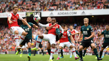 LONDON, ENGLAND - AUGUST 17: Alexandre Lacazette of Arsenal tangles with Erik Pieters of Burnley ahead of the opening goal during the Premier League match between Arsenal FC and Burnley FC at Emirates Stadium on August 17, 2019 in London, United Kingdom. (Photo by Michael Regan/Getty Images)