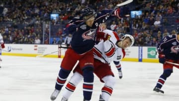 Nov 4, 2014; Columbus, OH, USA; Columbus Blue Jackets defenseman Jack Johnson (7) checks Carolina Hurricanes left wing Jiri Tlusty (19) during the first period at Nationwide Arena. Mandatory Credit: Russell LaBounty-USA TODAY Sports