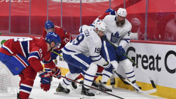 MONTREAL, QC - MAY 25: Corey Perry #94 of the Montreal Canadiens battles for the puck with Jason Spezza #19 and Joe Thornton #97 of the Toronto Maple Leafs during the first period in Game Four of the First Round of the 2021 Stanley Cup Playoffs at the Bell Centre on May 25, 2021 in Montreal, Canada. The Toronto Maple Leafs defeated the Montreal Canadiens 4-0. (Photo by Minas Panagiotakis/Getty Images)