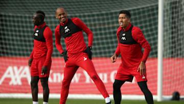 LIVERPOOL, ENGLAND - OCTOBER 22: Fabinho and Roberto Firmino share a joke during a Liverpool training session ahead of the Champions League group E match against KRC Genk at Melwood Training Ground on October 22, 2019 in Liverpool, England. (Photo by Jan Kruger/Getty Images)