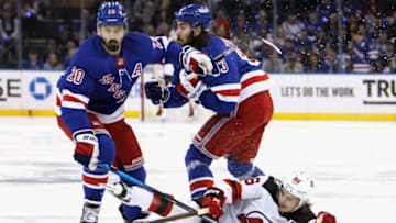 NEW YORK, NEW YORK - APRIL 29: Jack Hughes #86 of the New Jersey Devils is hit by Chris Kreider #20 of the New York Rangers during the first period in Game Six of the First Round of the 2023 Stanley Cup Playoffs at Madison Square Garden on April 29, 2023 in New York, New York. (Photo by Bruce Bennett/Getty Images)