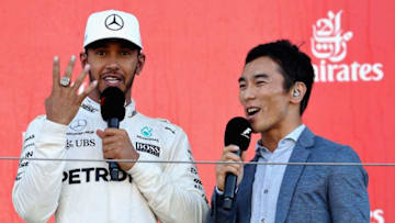 SUZUKA, JAPAN - OCTOBER 08: Race winner Lewis Hamilton of Great Britain and Mercedes GP talks with 2017 Indy 500 winner Takuma Sato of Japan on the podium during the Formula One Grand Prix of Japan at Suzuka Circuit on October 8, 2017 in Suzuka. (Photo by Mark Thompson/Getty Images)