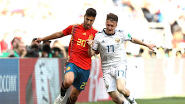 MOSCOW, RUSSIA - JULY 01: Marco Asensio of Spain and Aleksandr Golovin of Russia battle for the ball during the 2018 FIFA World Cup Russia Round of 16 match between Spain and Russia at Luzhniki Stadium on July 1, 2018 in Moscow, Russia. (Photo by Ryan Pierse/Getty Images)