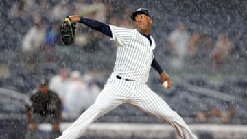 Jun 27, 2016; Bronx, NY, USA; New York Yankees relief pitcher Aroldis Chapman (54) pitches in the rain against the Texas Rangers during the ninth inning at Yankee Stadium. Mandatory Credit: Brad Penner-USA TODAY Sports