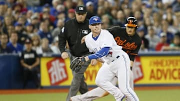 Jun 19, 2015; Toronto, Ontario, CAN; Toronto Blue Jays third baseman Josh Donaldson (20) chases a wild throw as Baltimore Orioles third baseman Manny Machado (13) is safe at third in the eighth inning at Rogers Centre. Toronto defeated Baltimore 5-4. Mandatory Credit: John E. Sokolowski-USA TODAY Sports