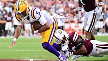 Sep 16, 2023; Starkville, Mississippi, USA; LSU Tigers quarterback Jayden Daniels (5) runs the ball for a touchdown while defended by Mississippi State Bulldogs safety Isaac Smith (20) during the third quarter at Davis Wade Stadium at Scott Field. Mandatory Credit: Matt Bush-USA TODAY Sports