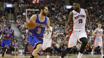 Dec 21, 2014; Toronto, Ontario, CAN; New York Knicks guard Jose Calderon (3) dribbles the ball as Toronto Raptors forward Amir Johnson (15) defends at the Air Canada Centre. The Raptors won 118-108. Mandatory Credit: John E. Sokolowski-USA TODAY Sports