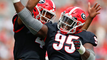 Nolan Smith #4 reacts with defensive tackle Noah Chumley #95 of the Georgia Bulldogs after a sack during the second half of the G-Day spring game at Sanford Stadium on April 17, 2021 in Athens, Georgia. (Photo by Todd Kirkland/Getty Images)