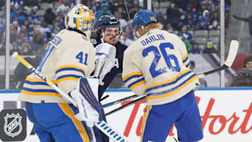 HAMILTON, ON - MARCH 13: Auston Matthews #34 of the Toronto Maple Leafs gets into a battle with Rasmus Dahlin #26 of the Buffalo Sabres in the 2022 Tim Hortons NHL Heritage Classic at Tim Hortons Field on March 13, 2022 in Hamilton, Ontario, Canada. The Sabres defeated the Maple Leafs 5-2. (Photo by Claus Andersen/Getty Images)