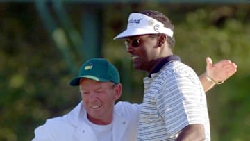 AUGUSTA, : Vijay Singh of Fiji (L) is hugged by his caddie David Renwick (L) after Singh made the final putt on the 18th green 09 April, 2000 to win the Masters Golf Tournament at Augusta National Golf Club in Augusta, GA. Singh finished at ten under par. (ELECTRONIC IMAGE) AFP PHOTO/Jeff HAYNES (Photo credit should read JEFF HAYNES/AFP via Getty Images)