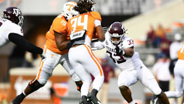Texas A&M linebacker Aaron Hansford (33) defends Tennessee defensive back Trel Riley (34) during a game between Tennessee and Texas A&M in Neyland Stadium in Knoxville, Saturday, Dec. 19, 2020.