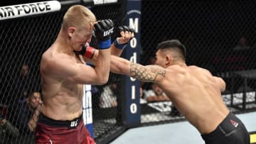 LAS VEGAS, NEVADA - DECEMBER 14: (R-L) Punahele Soriano punches Oskar Piechota of Poland in their middleweight bout during the UFC 245 event at T-Mobile Arena on December 14, 2019 in Las Vegas, Nevada. (Photo by Jeff Bottari/Zuffa LLC)