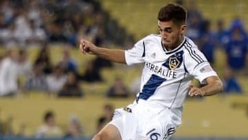 Aug 3, 2013; Los Angeles, CA, USA; Los Angeles Galaxy midfielder Hector Jimenez (16) leaps over Juventus midfielder Claudio Marchisio (8) during second half action at the Guiness International Champions Cup semifinals at Dodger Stadium. Mandatory Credit: Robert Hanashiro-USA TODAY Sports