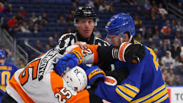 Sep 27, 2022; Buffalo, New York, USA; The linesman breaks up a fight between Philadelphia Flyers left wing James van Riemsdyk (25) and Buffalo Sabres defenseman Ilya Lyubushkin (46) during the third period at KeyBank Center. Mandatory Credit: Timothy T. Ludwig-USA TODAY Sports
