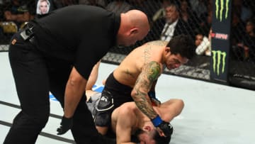 AUSTIN, TX - FEBRUARY 18: (L-R) Referee Dan Miragliotta monitors Diego Ferreira of Brazil as he punches Diego Ferreira of Brazil in their lightweight bout during the UFC Fight Night event at Frank Erwin Center on February 18, 2018 in Austin, Texas. (Photo by Josh Hedges/Zuffa LLC/Zuffa LLC via Getty Images)